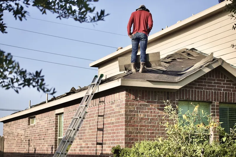 Professional roofer working on a residential roof in Meriams Corner